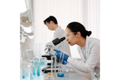 Doctor looking through a microscope